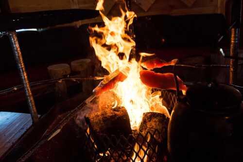 Grilling meat on bonfire
